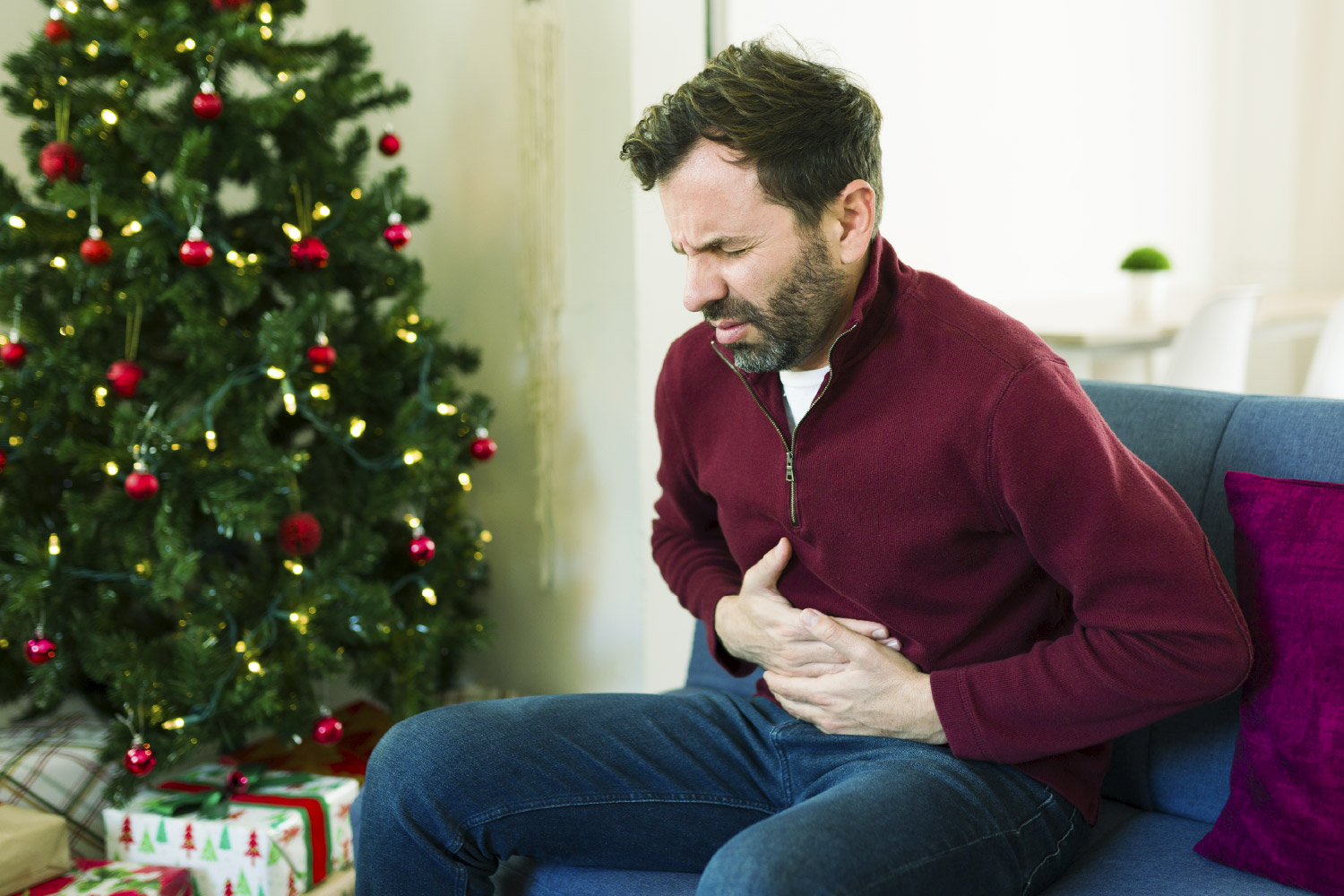 Hombre con indigestión causada por la cena de Navidad