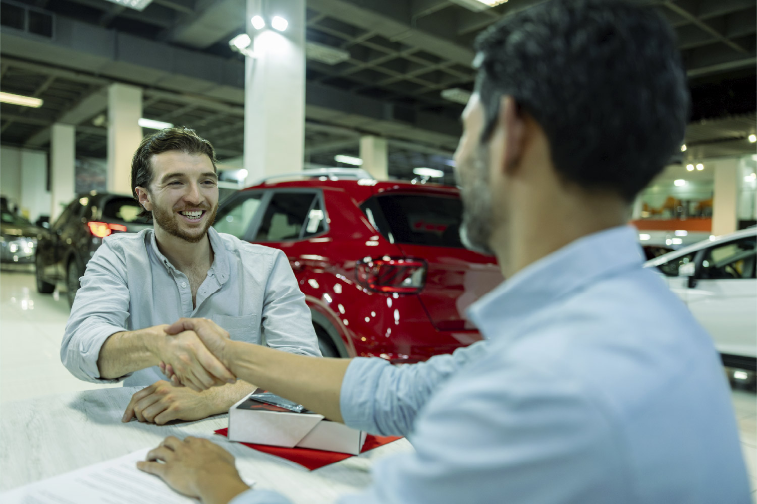 Hombre contratando seguro vehicular para su auto nuevo